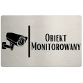 Tabliczka informująca o monitoringu wizyjnym na posesji.