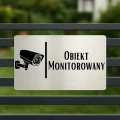 Oznaczenie z ikoną kamery i napisem „Obiekt monitorowany”.