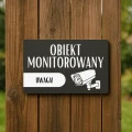 Oznaczenie systemu CCTV na zapleczu lub magazynie.