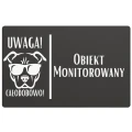 Tablica z napisem „Obiekt monitorowany” i grafiką psa z kamerą.
